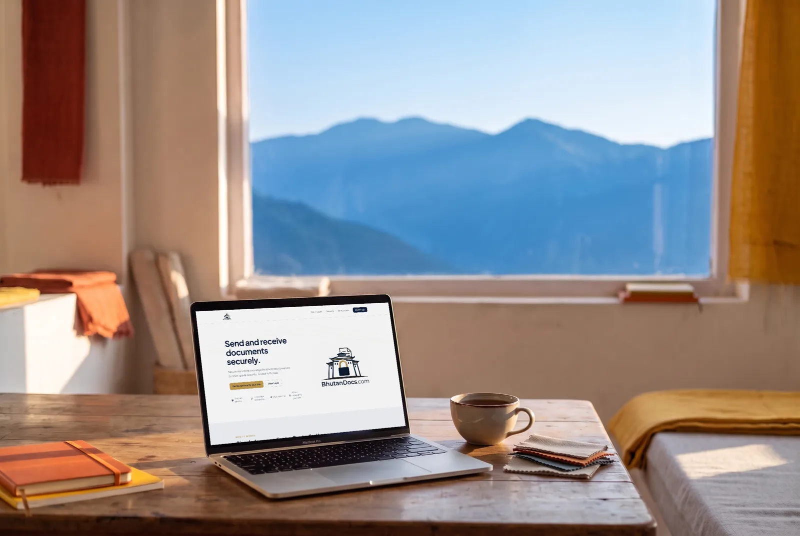 The BhutanDocs website on a laptop, with mountains through the window